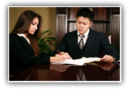 man and woman signing legal power of attorney document